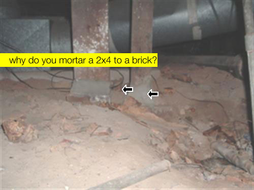 Photo of a 2x4 mortared to a brick. Why?
